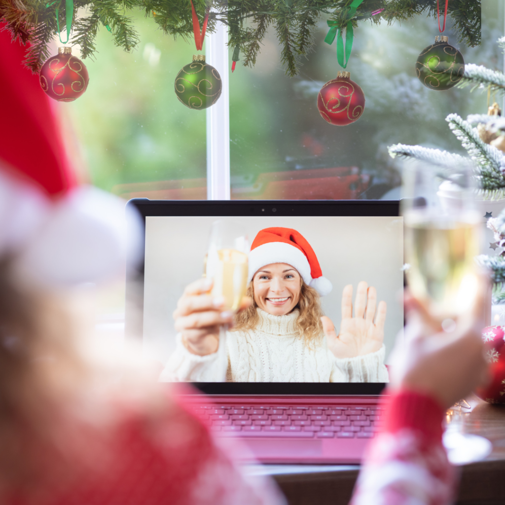 woman on computer raising glass in toast