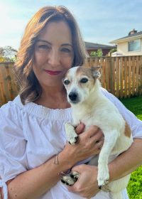 woman holding small dog